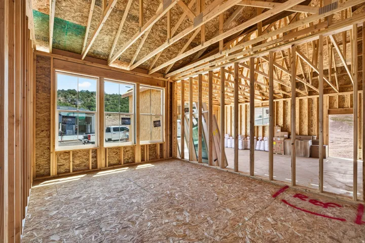 New construction framing featuring large windows and an open-concept layout