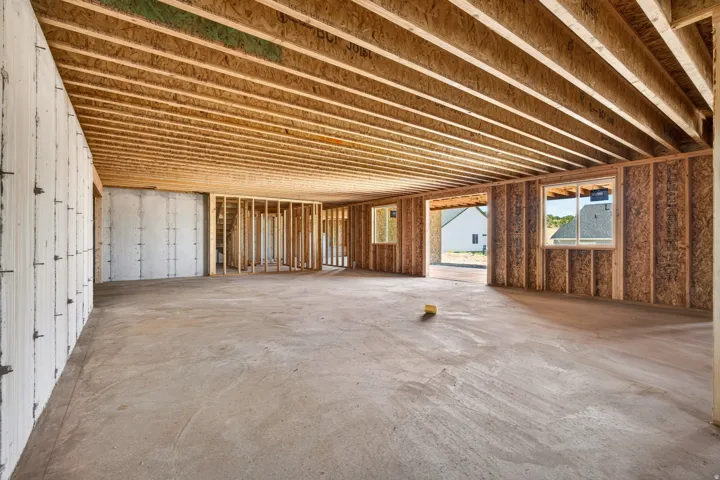Unfinished basement space with concrete flooring