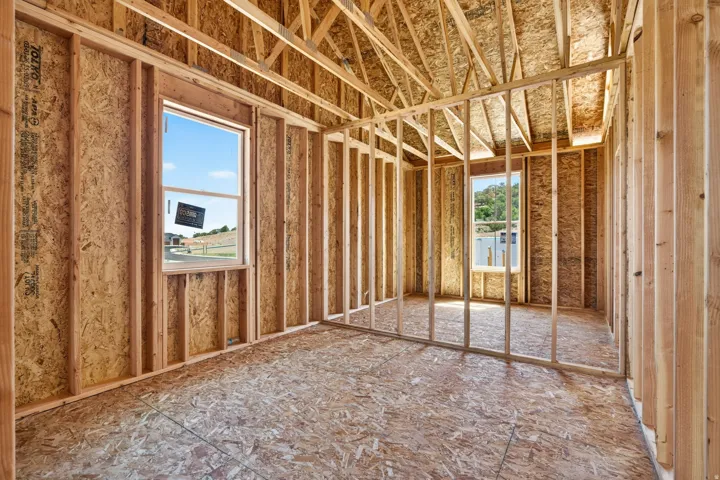Unfinished interior space featuring exposed wood framing, oriented strand board walls, and subflooring