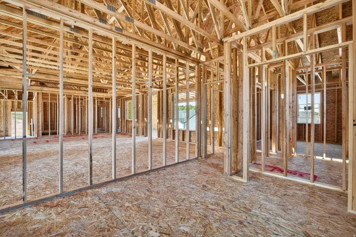 Interior framing showcasing structural wood elements and oriented strand board subflooring