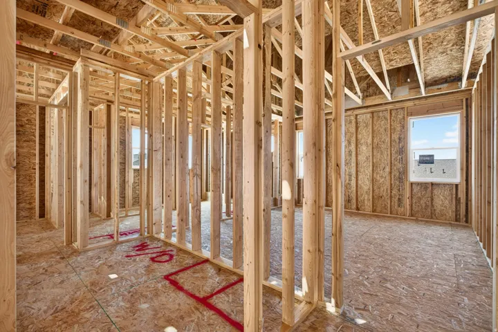 Interior framing showcasing unfinished construction with exposed wood studs and oriented strand board walls