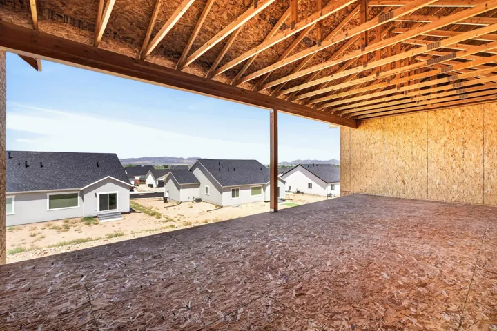 Open-concept interior framing, exposed wooden joists, and oriented strand board walls