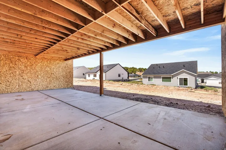 Concrete patio with a structural wood ceiling, supported by a single wood post