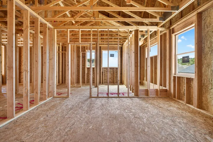 New construction framing with multiple window openings providing ambient light