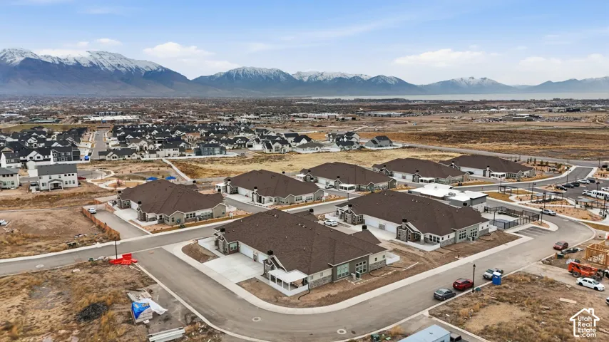 Newly constructed homes featuring a modern architectural style and dark shingle roofing