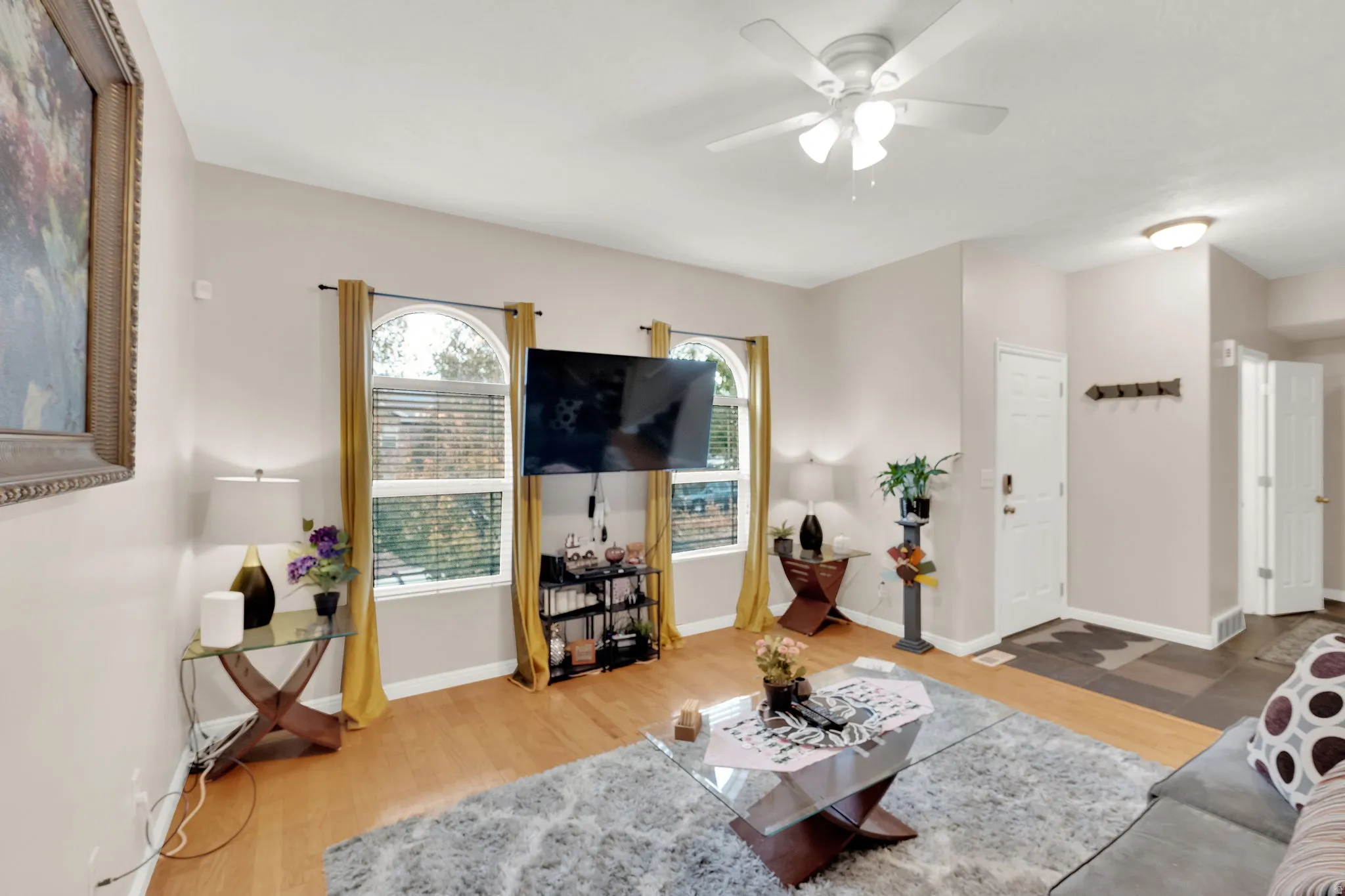 Living area with wood-finish flooring and light neutral wall tones