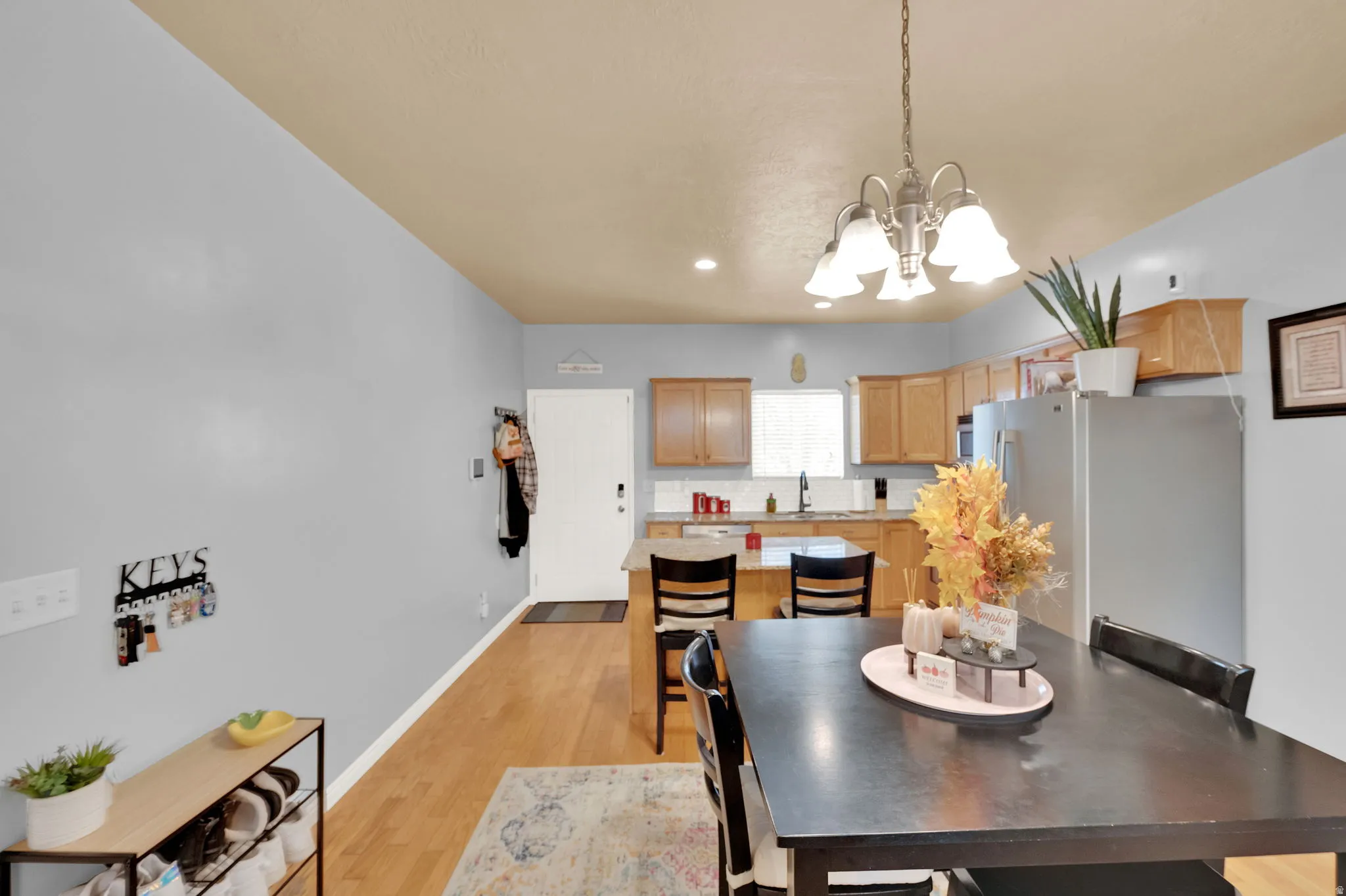 Open-concept kitchen and dining area featuring wood-finish flooring