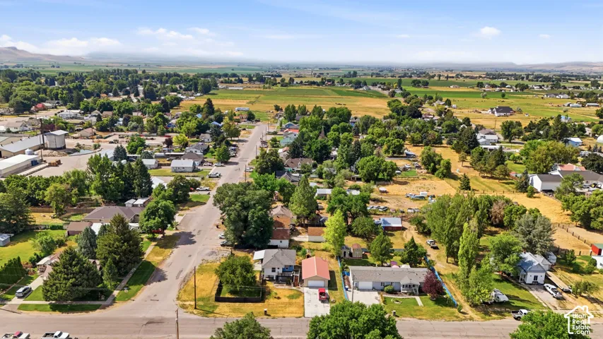 Expansive aerial perspective showcasing a residential neighborhood with a mix of established homes and mature trees