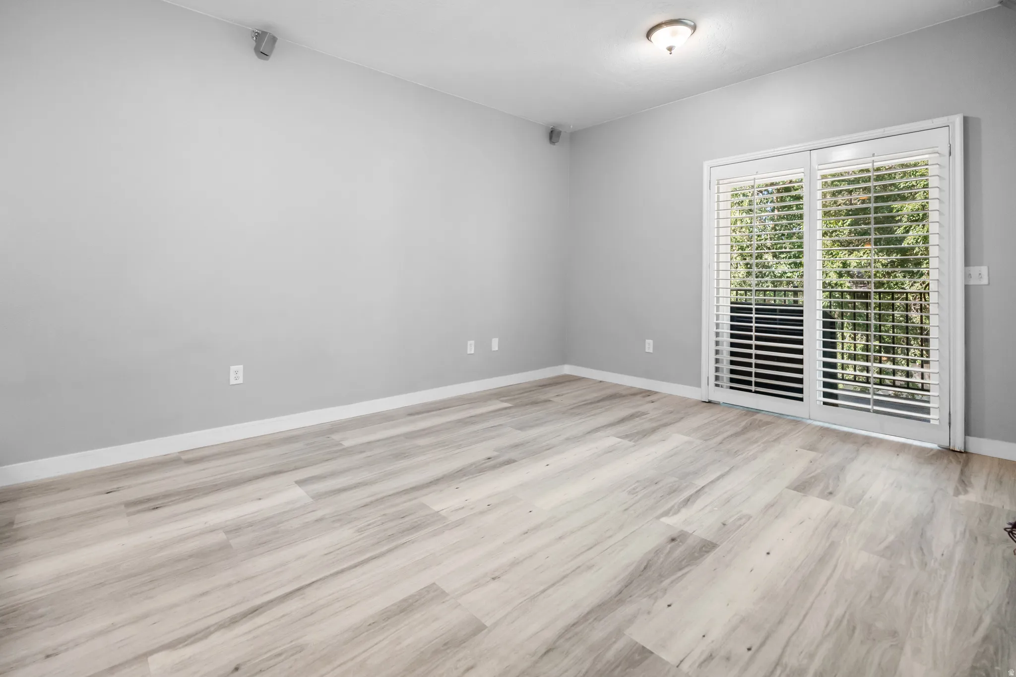 Room featuring wood-finish flooring and light gray walls