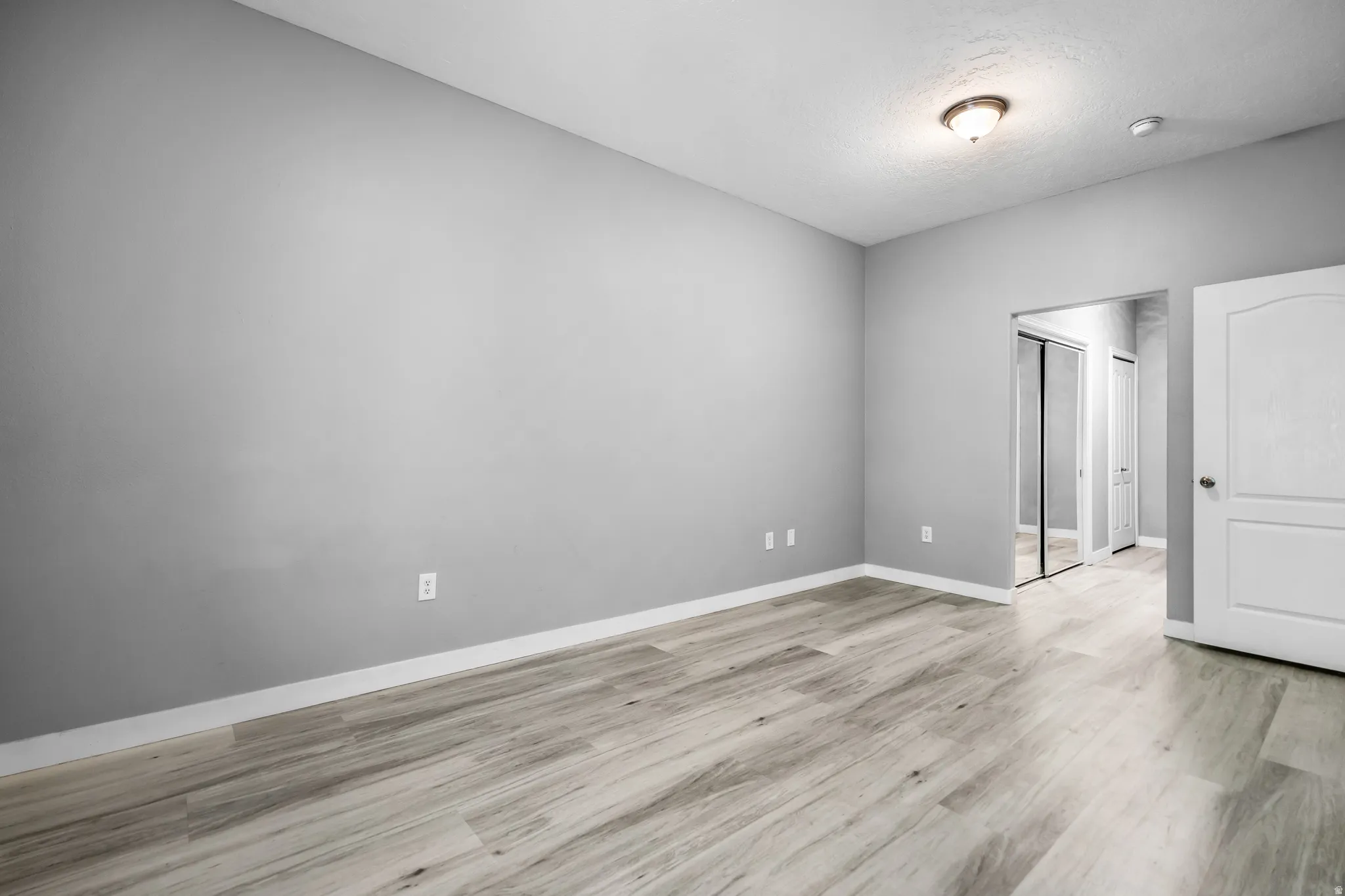 Neutral gray walls complemented by wood-finish flooring