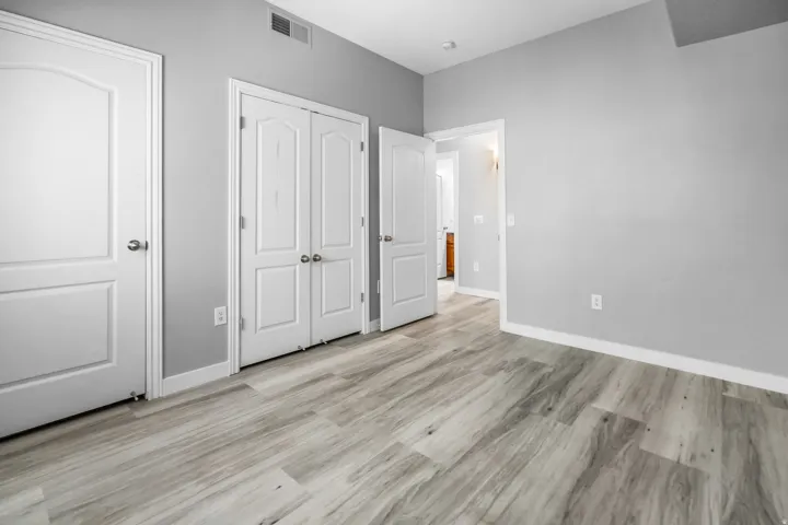 Room featuring light wood-finish flooring, light gray walls, and white trim