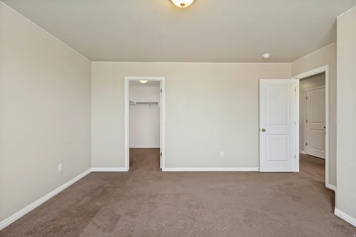Carpeted room with neutral wall tones