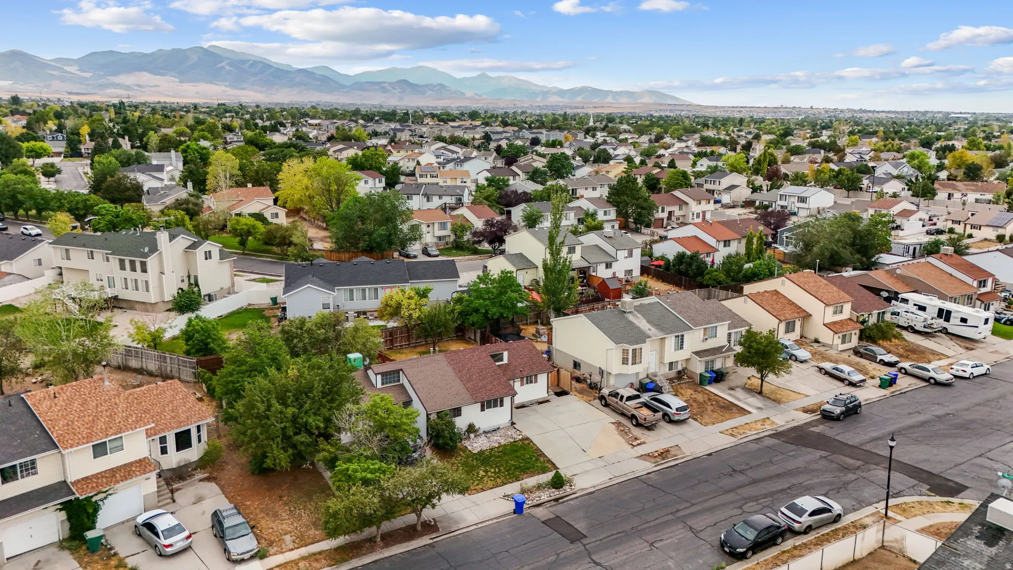 Aerial view of property and residential neighborhoods with Oquirrh mountains.