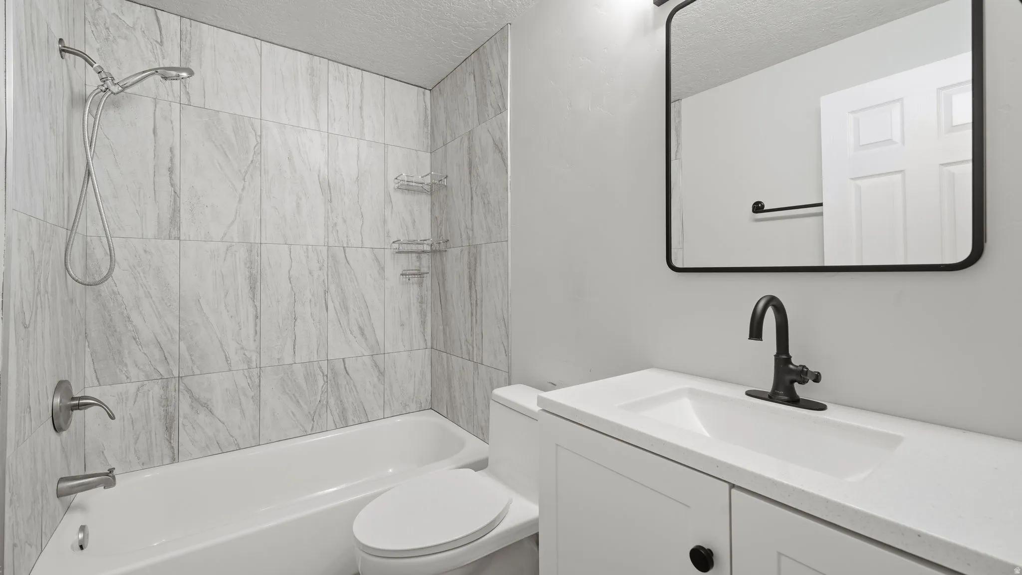 Full bathroom with contemporary tile design and white vanity.
