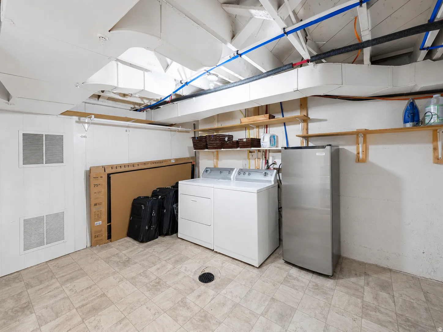 Laundry area featuring a top-loading washer and front-loading dryer