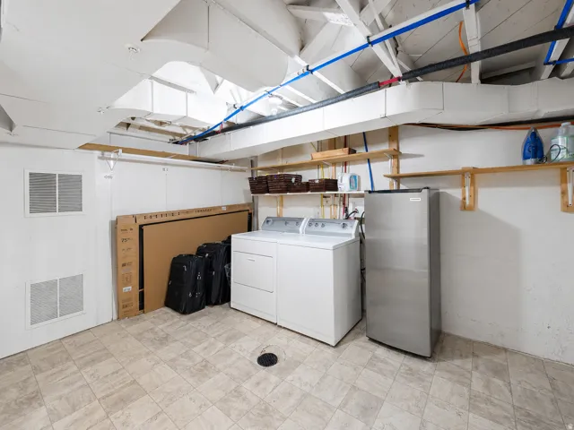 Laundry area featuring a top-loading washer and front-loading dryer