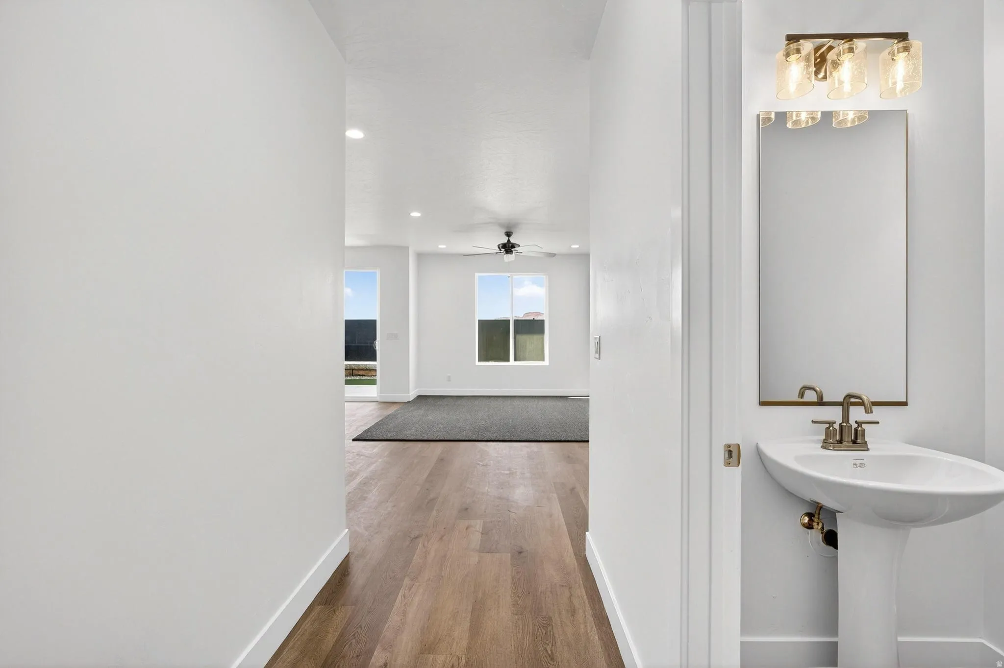 Entryway featuring wood-finish flooring, white walls, and recessed lighting