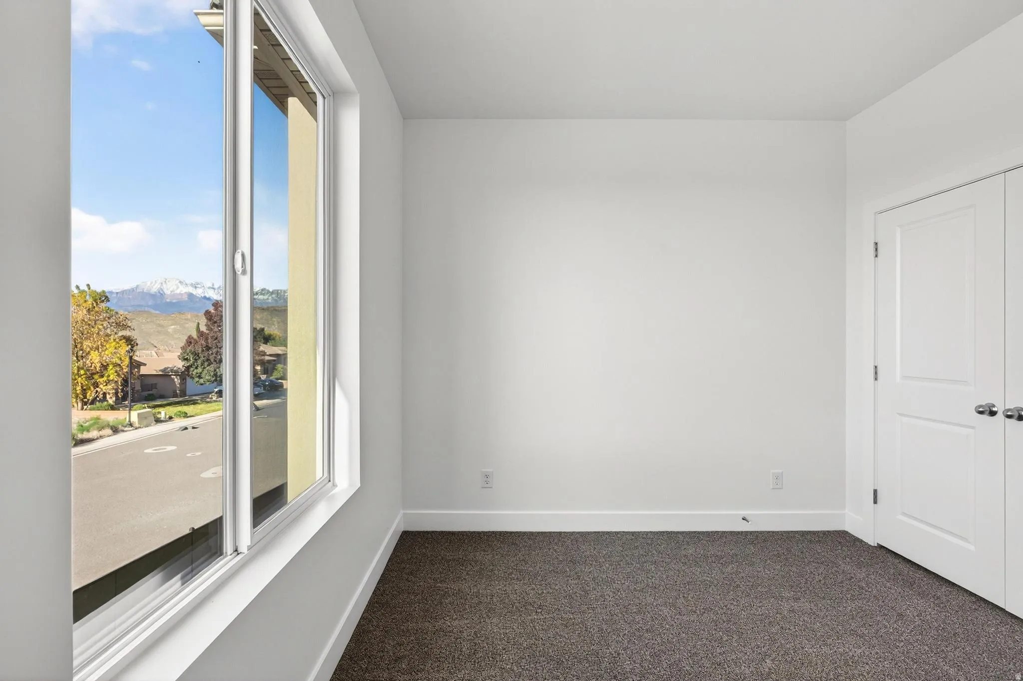 Bright interior space featuring a large window with a mountain backdrop
