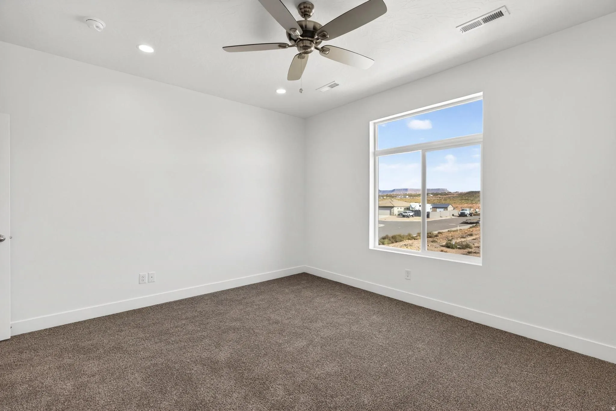 Neutral-toned carpet flooring complementing white walls