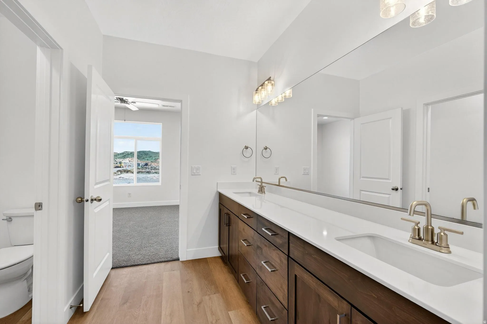 Dual vanity with white countertop, undermount sinks, and brushed nickel fixtures