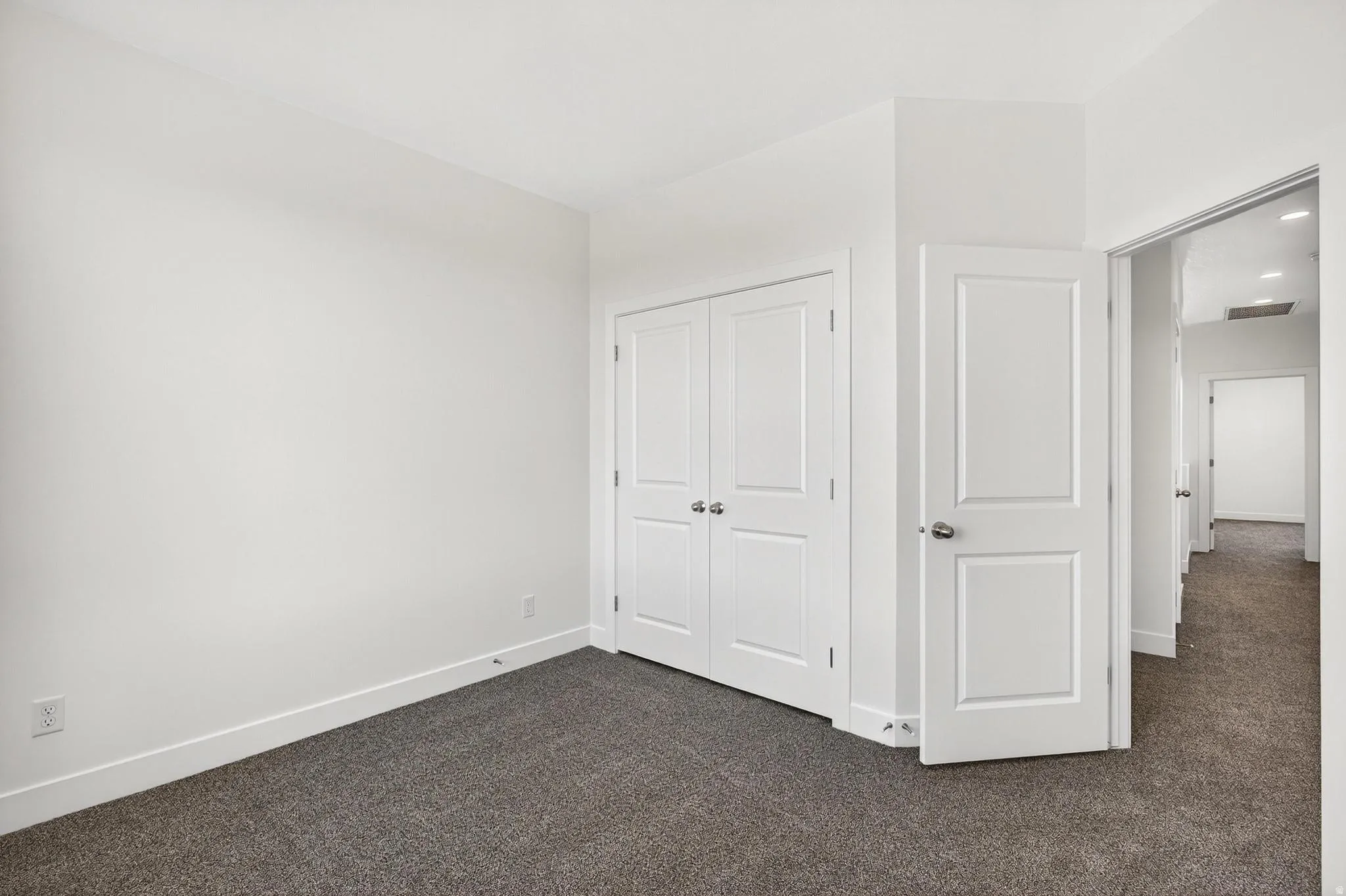 Room featuring neutral wall finishes and plush carpet flooring