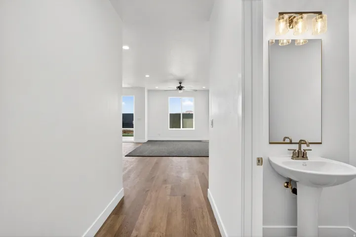 Entryway featuring wood-finish flooring, white walls, and recessed lighting