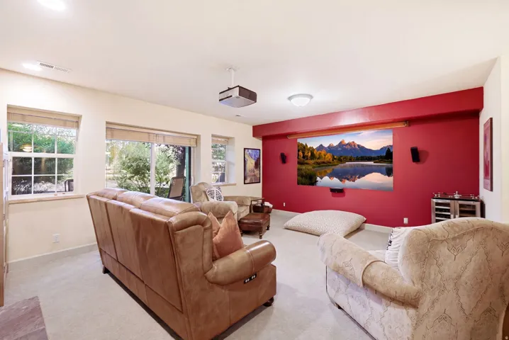 Dedicated media room featuring a large projector screen and built-in speakers