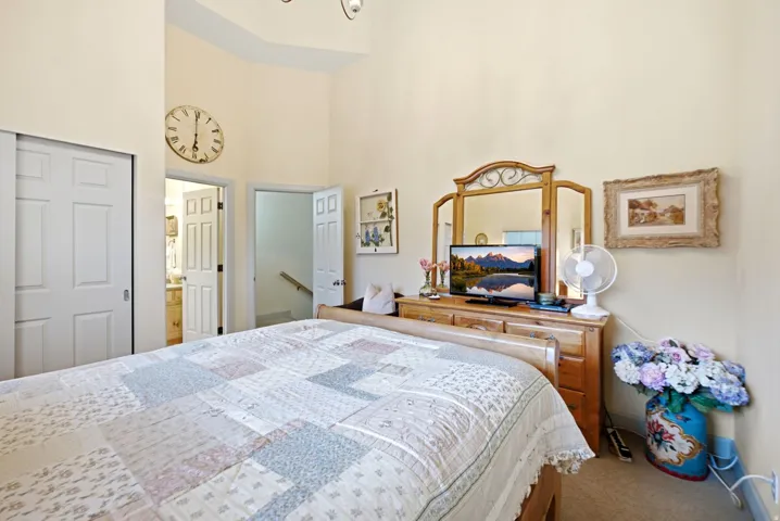 Bedroom featuring vaulted ceilings and neutral wall paint