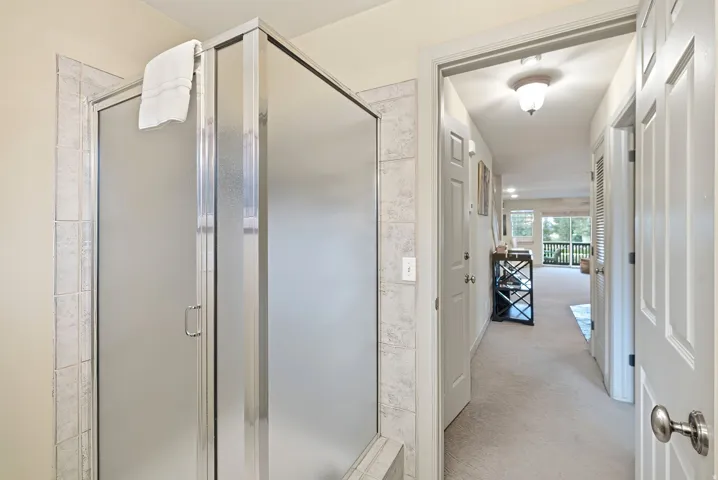 Frosted glass shower enclosure with chrome framing and a tile surround