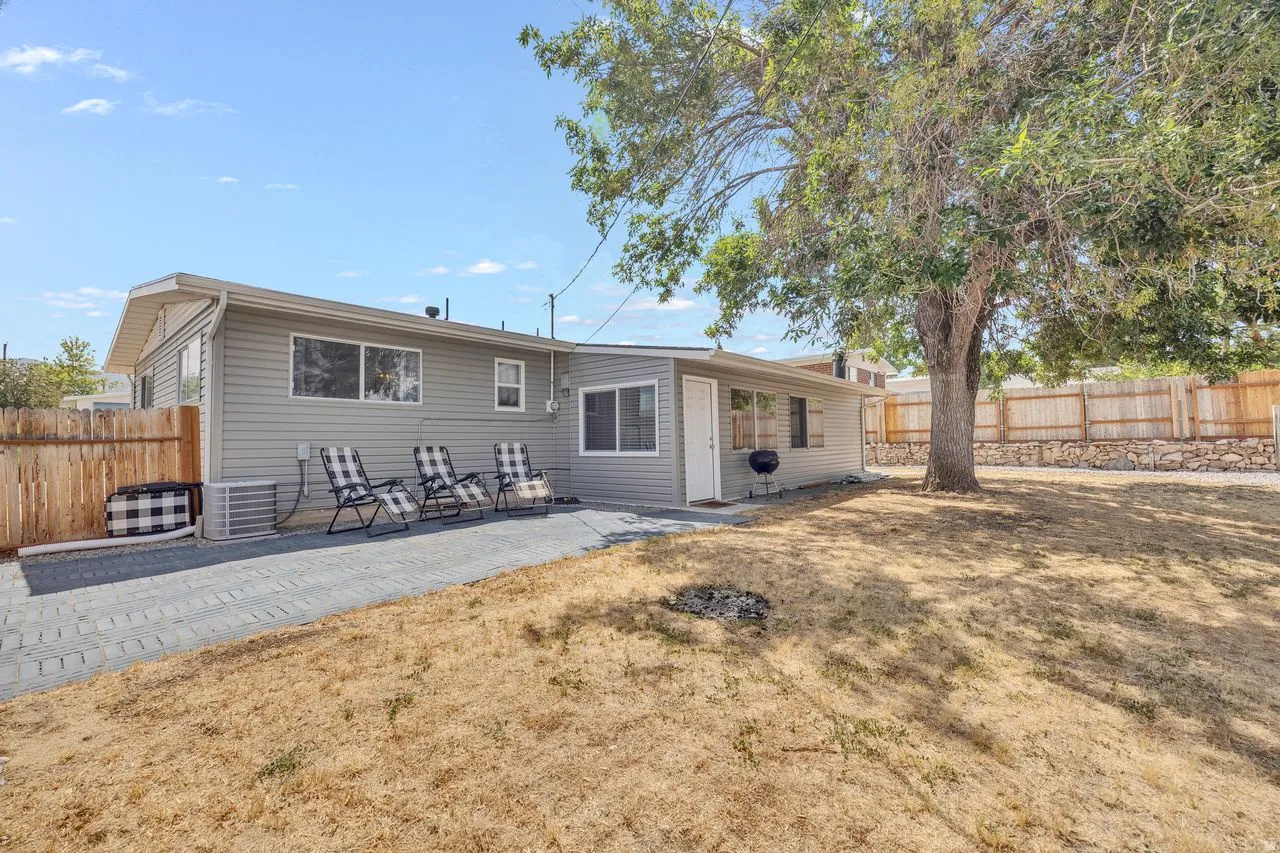 Rear exterior featuring light grey horizontal siding