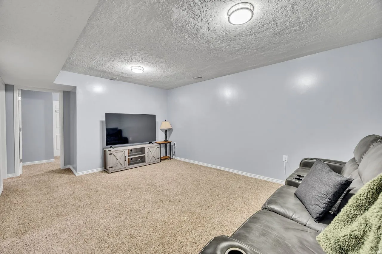 Carpeted interior space with light blue walls and white trim