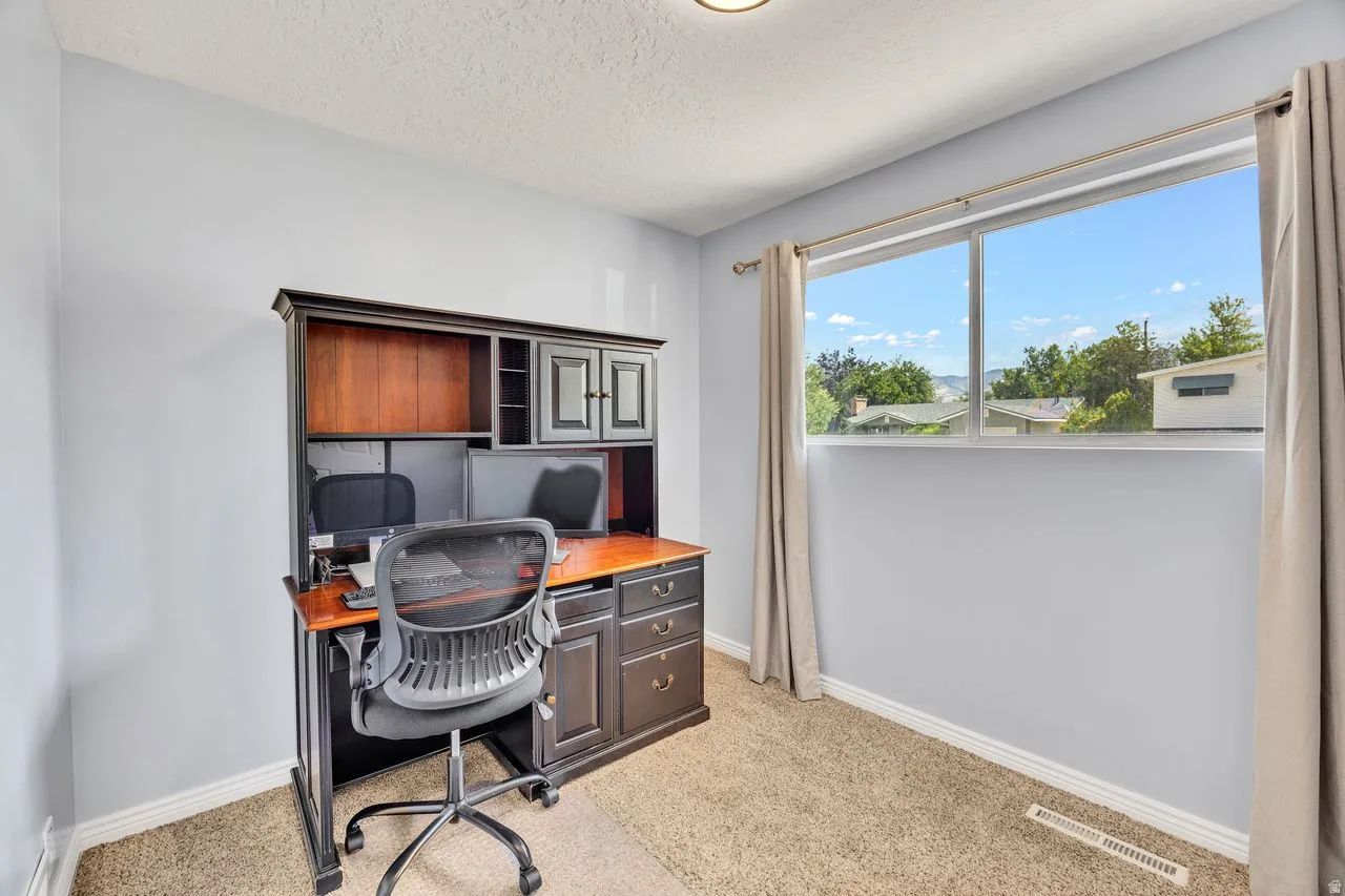 Room featuring neutral carpeting and light-toned walls