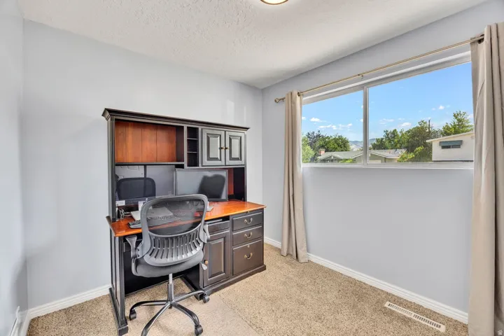 Room featuring neutral carpeting and light-toned walls