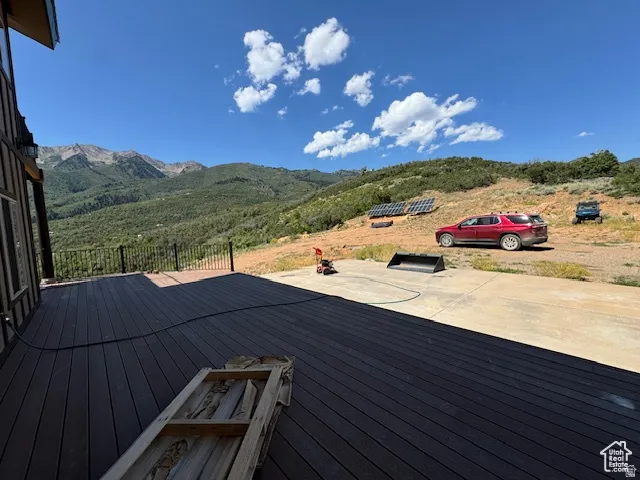 Expansive outdoor deck featuring dark composite decking and a black metal railing