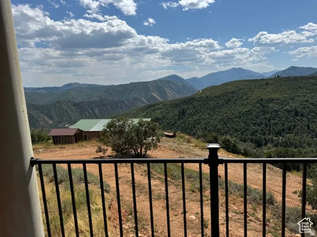 Expansive mountain landscape with rolling, tree-covered hills