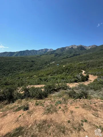 Expansive mountain scenery with a clear blue sky overhead