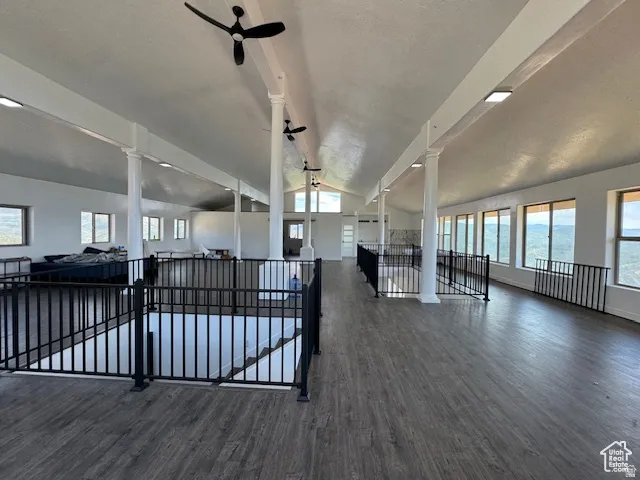 Expansive open-concept upper level featuring wood-finish flooring and numerous windows