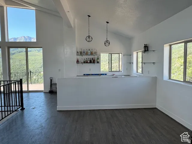 Vaulted ceilings with abundant natural light from multiple windows and glass sliding doors
