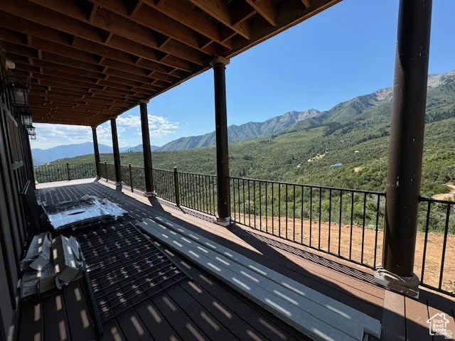 Expansive outdoor deck featuring composite decking and black wrought iron railings