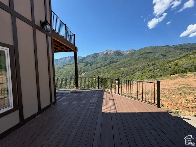 Expansive outdoor deck featuring composite decking and a black metal railing