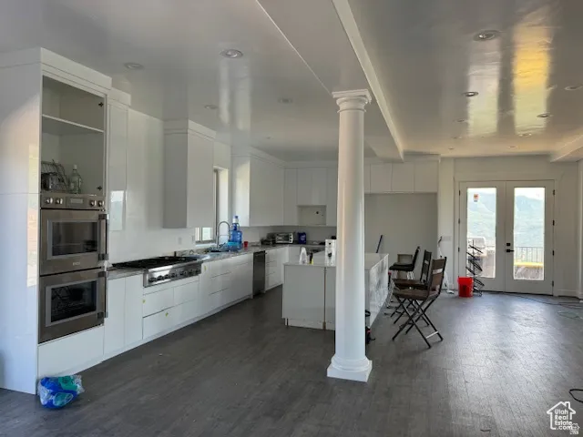 Spacious kitchen featuring white cabinetry and light-toned countertops