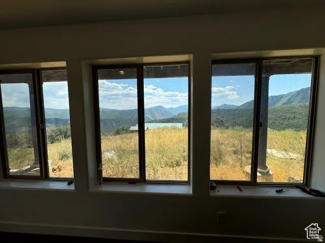 Wall of three large windows framing expansive mountainous scenery