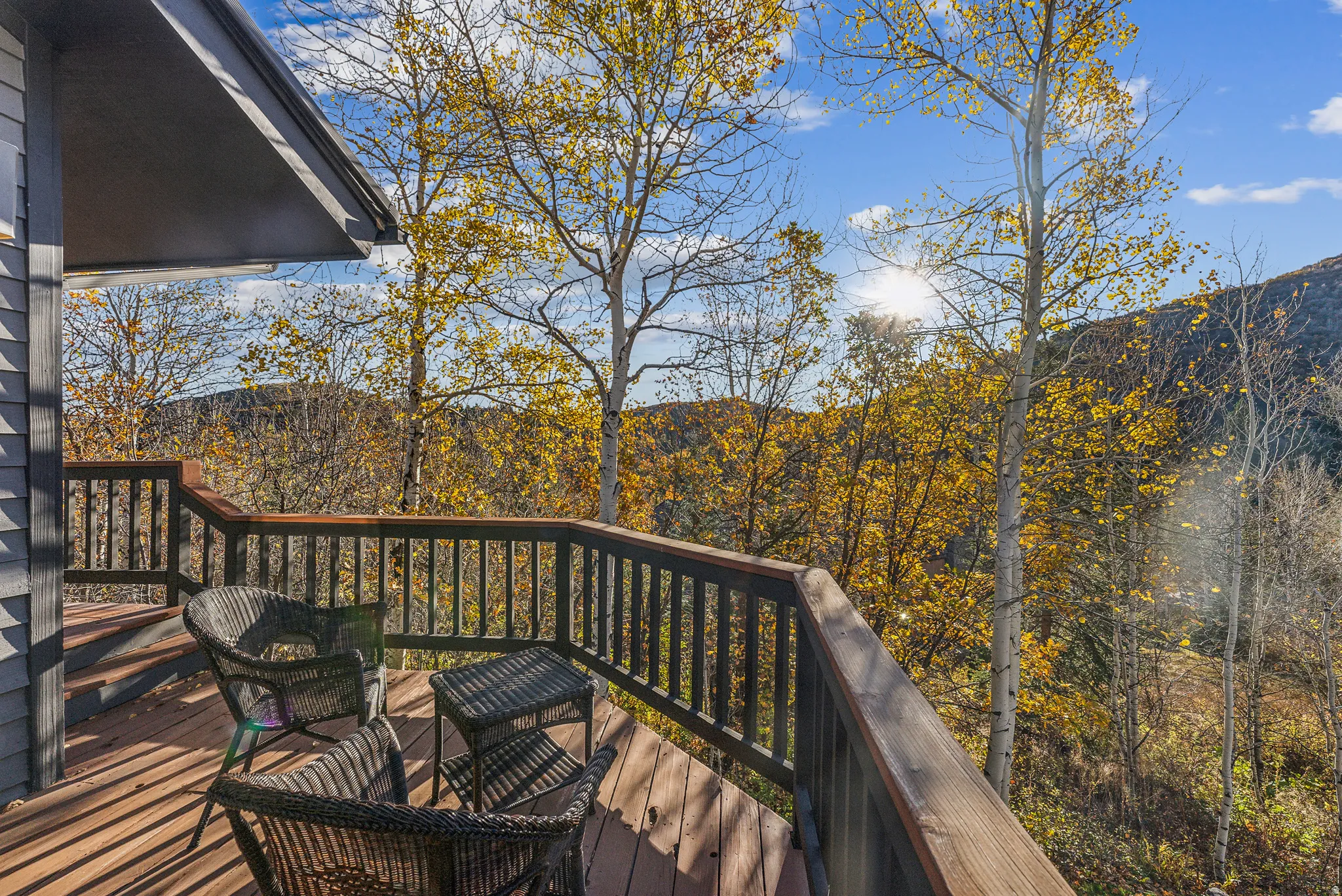 Wood-finish deck with dark railings, featuring a tiered design and multiple levels