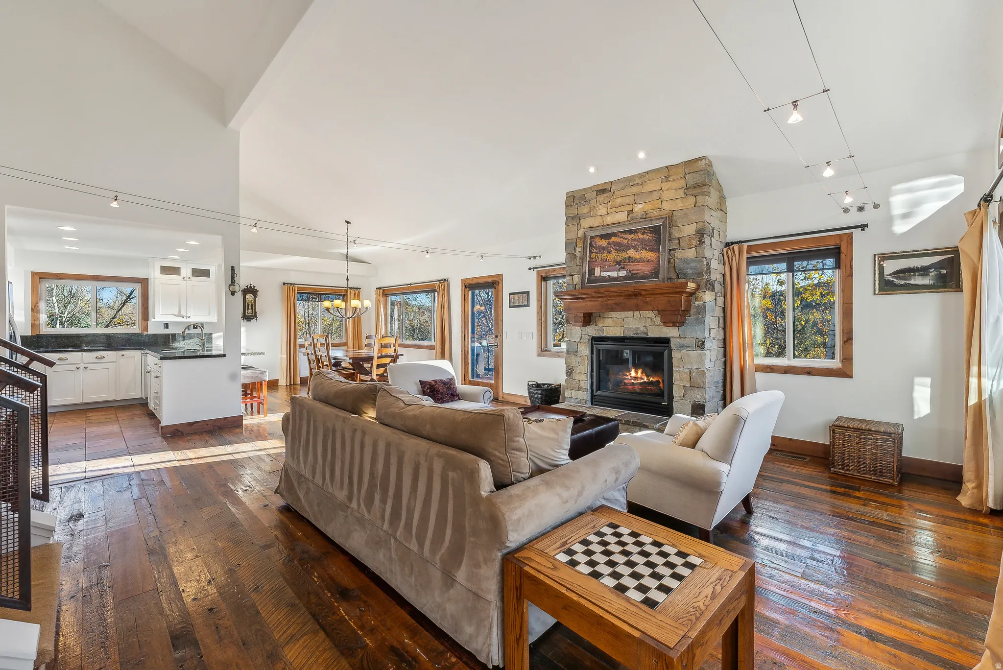 Stone fireplace with a substantial wood mantelpiece forms a central feature