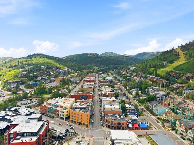 Elevated perspective showcasing a vibrant townscape nestled within a mountainous landscape