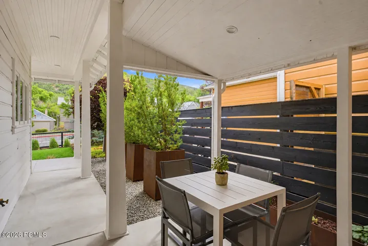 Covered patio with a smooth concrete surface and recessed lighting