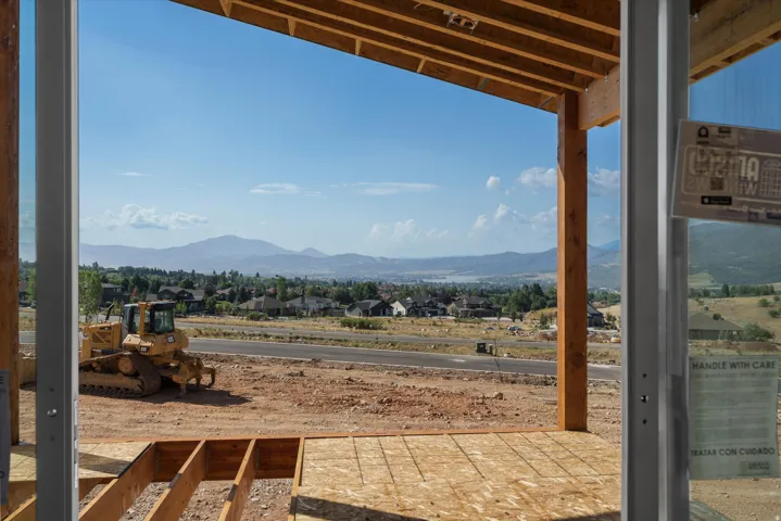 Expansive mountain and distant water scenery frames the horizon, complemented by visible neighborhood dwellings