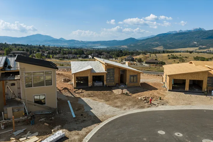 New construction homes with modern architectural design, featuring sloped roofs and large window placements
