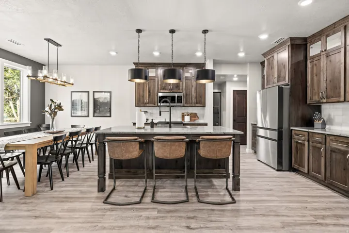 Open-concept kitchen and dining area featuring light wood-finish flooring