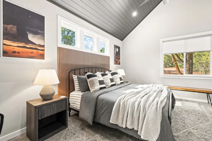 Vaulted ceiling with dark wood paneling and recessed lighting